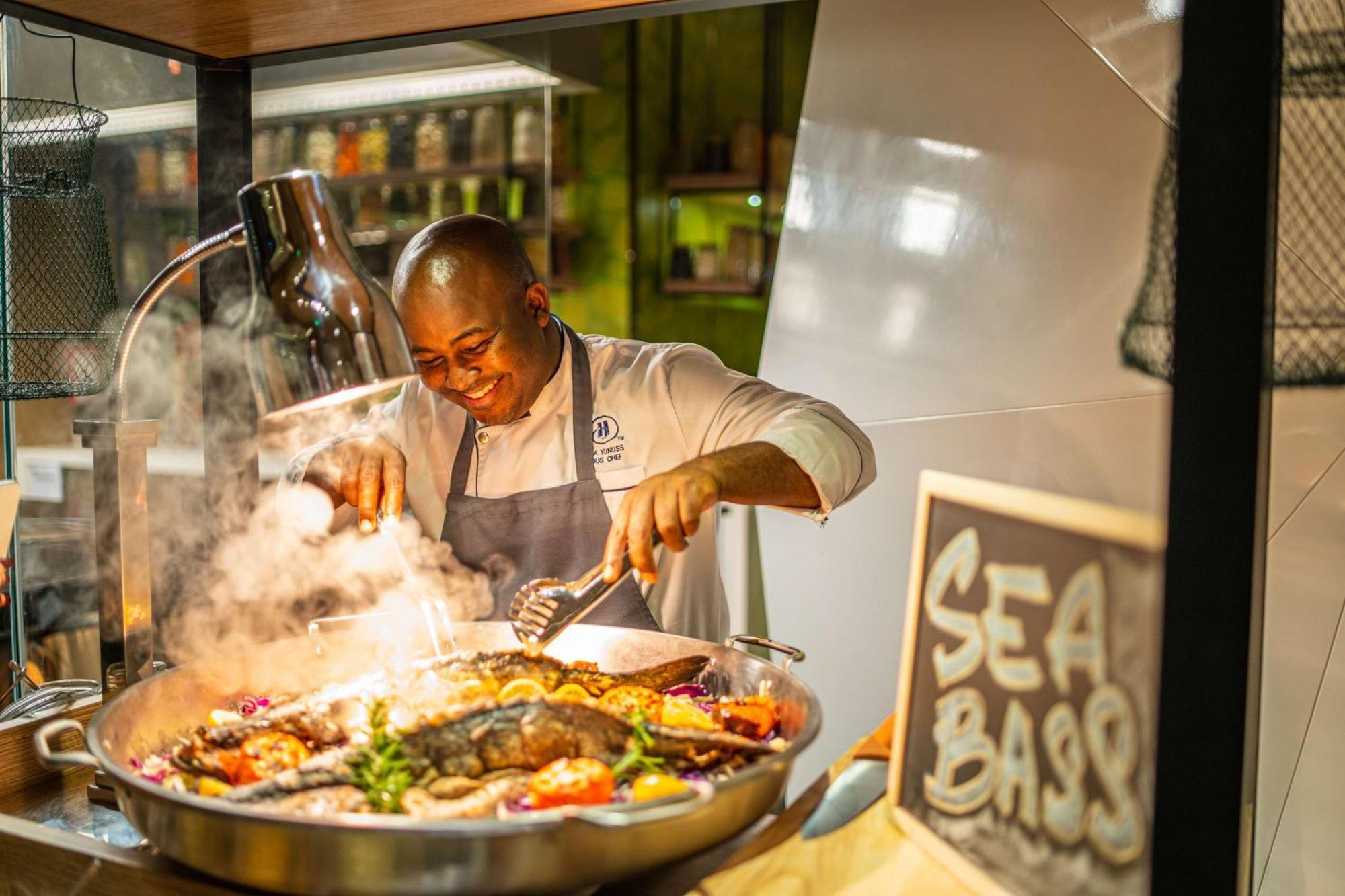 Hilton Bahrain Hotel Manama Ngoại thất bức ảnh Chef preparing food at the Sea Bass restaurant